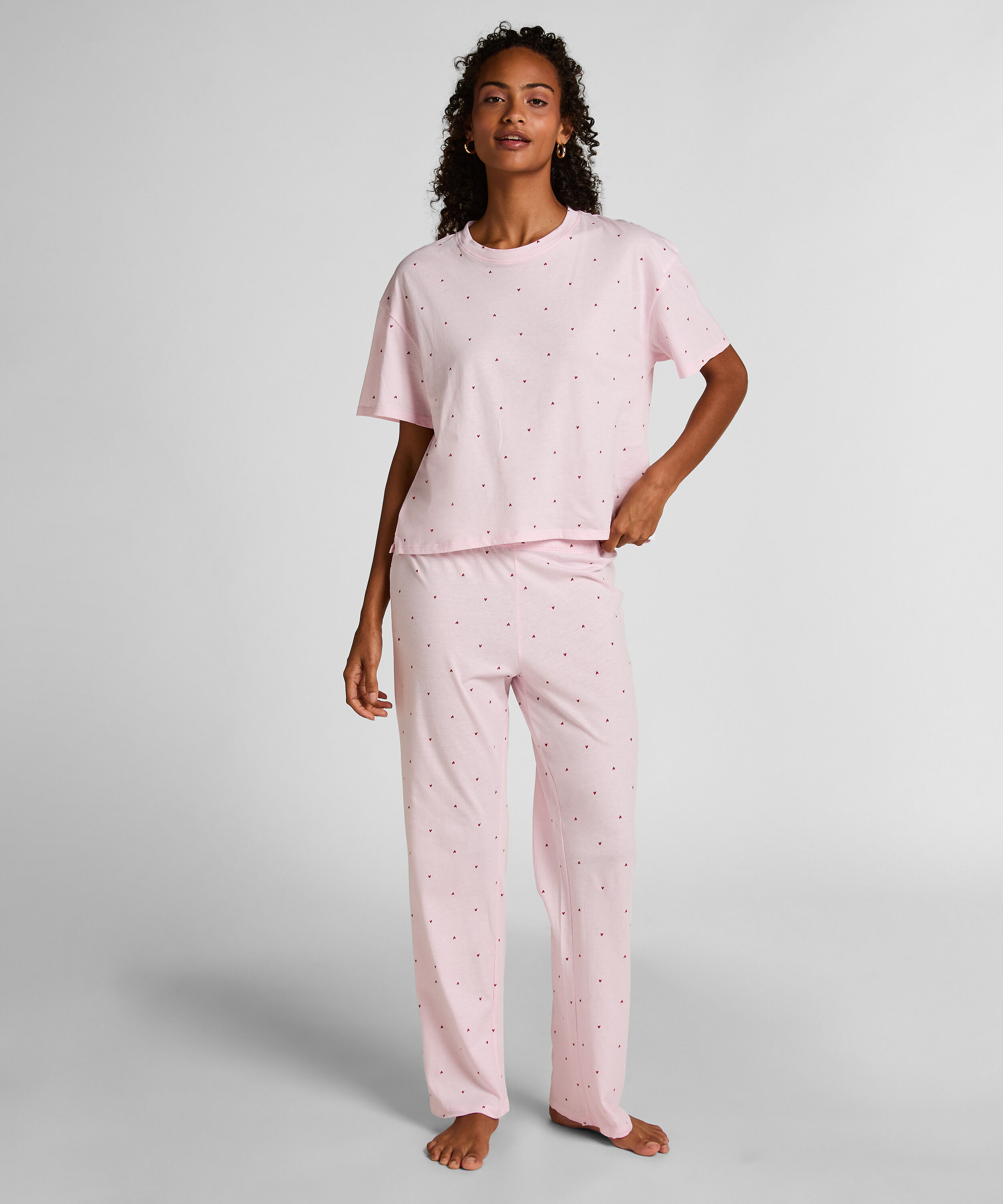 Cozy up in style with this charming pyjama set, designed for ultimate comfort and playful flair. Made from soft, breathable fabric, the set features long pants with an elasticated waist for a perfect, flexible fit and a short-sleeved top. Together, they create a relaxed, coordinated look ideal for lounging or sleeping., Pink