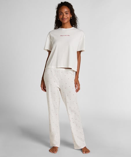 Cozy up in style with this charming pyjama set, designed for ultimate comfort and playful flair. Made from soft, breathable fabric, the set features long pants with an elasticated waist for a perfect, flexible fit and a short-sleeved top. Together, they create a relaxed, coordinated look ideal for lounging or sleeping., White